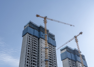 Tower crane on construction site - stock photo