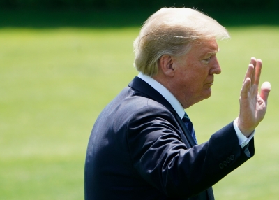 US President Donald Trump walks across the South Lawn